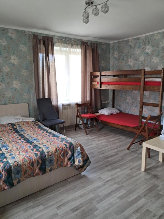 1 dormitorio con 2 literas y 1 silla en Sparta Apartments Kosmonaudi, en Narva