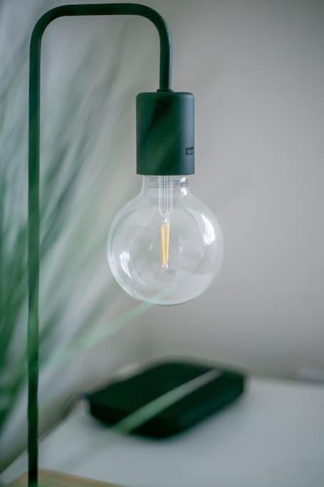 a glass light hanging from a wall at Coastal Haven in Leigh-on-Sea in Southend-on-Sea