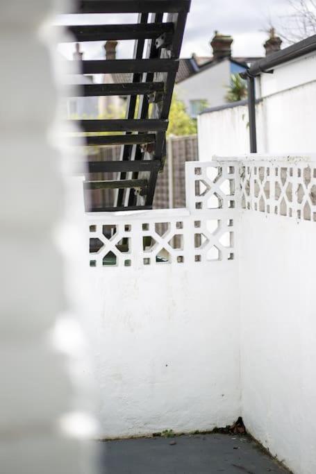 a white fence next to a white house at Coastal Haven in Leigh-on-Sea in Southend-on-Sea
