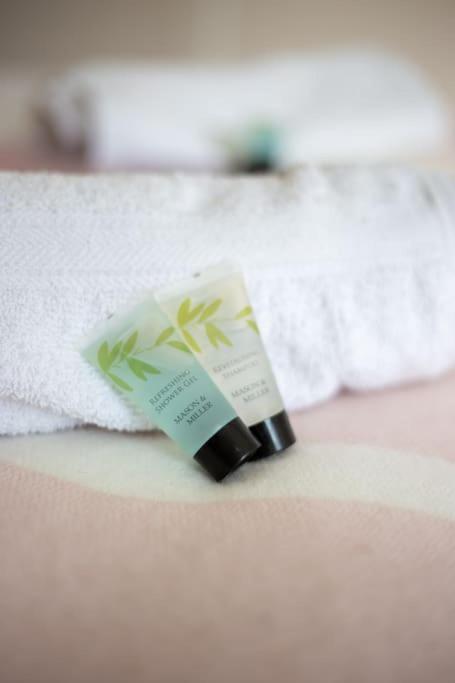 a bottle of moisturizing cream sitting on top of a towel at Coastal Haven in Leigh-on-Sea in Southend-on-Sea