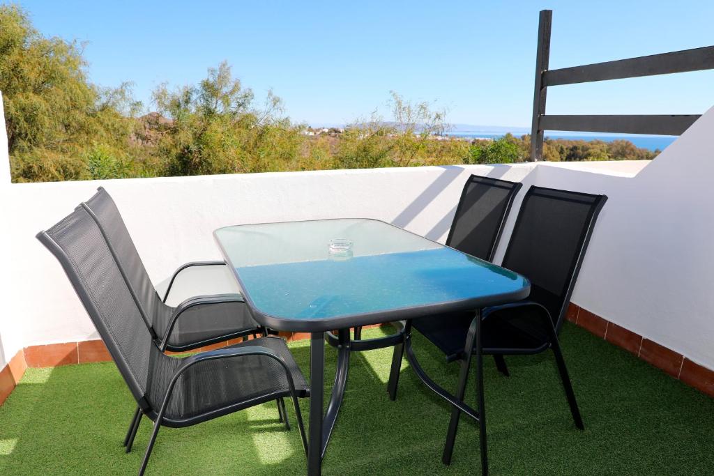 a blue table and chairs on a balcony at Duplex Mojácar Beach in Mojácar