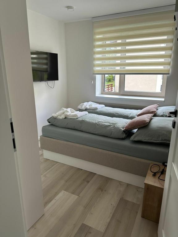 Postel nebo postele na pokoji v ubytování Apartmán Oriens Pec pod Sněžkou