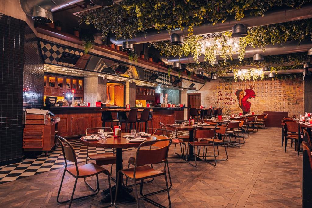 a restaurant with tables and chairs and a bar at TRYP by Wyndham Dubai in Dubai