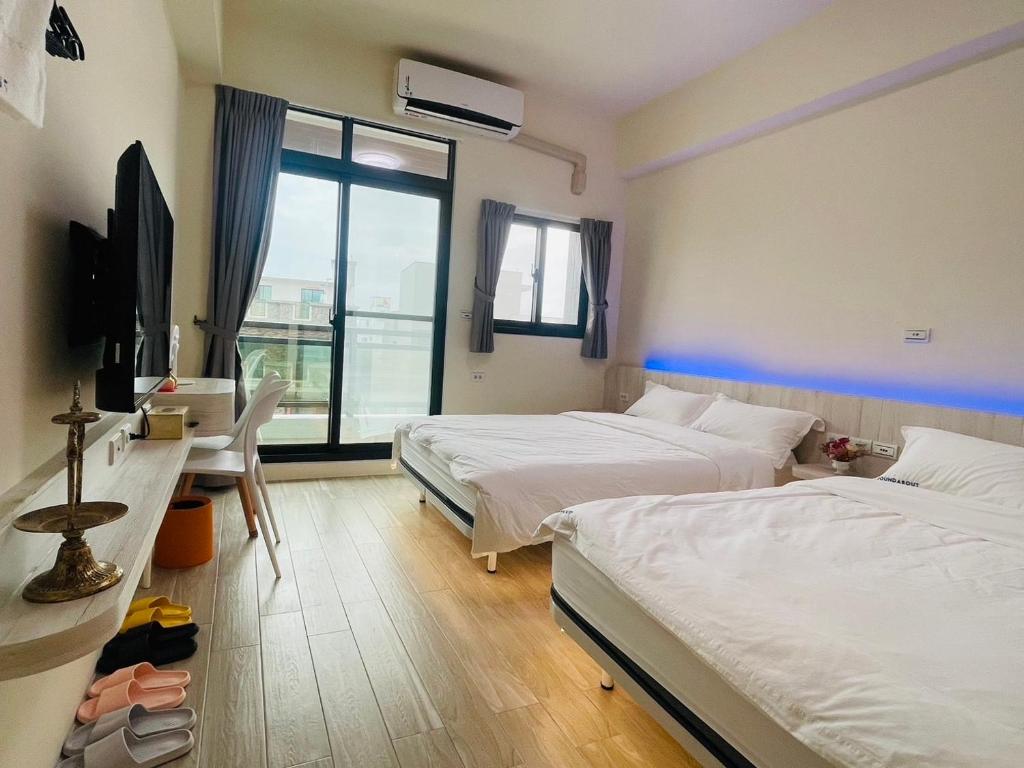 Postel nebo postele na pokoji v ubytování Penghu Roundabout Guesthouse