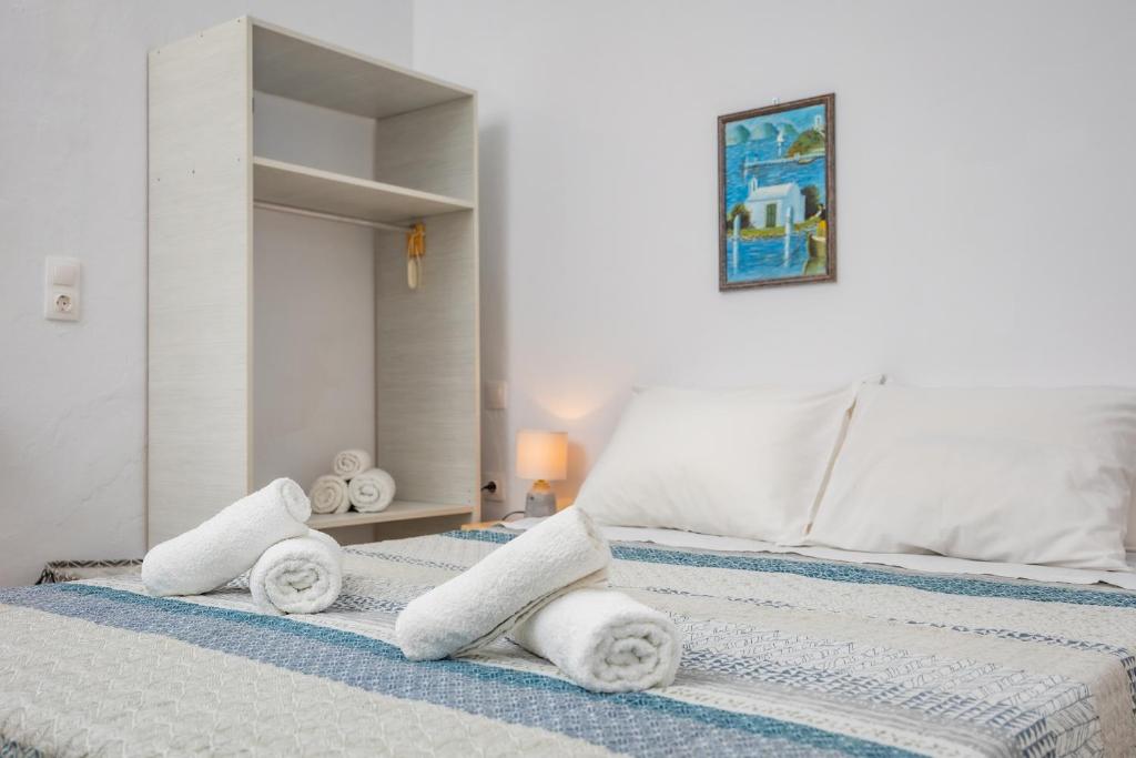 two beds with towels on them in a bedroom at FEEL THE SERENITY in Galini