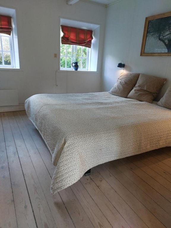 a bedroom with a large bed in a room at Strandvejen 52, Reersø in Reersø
