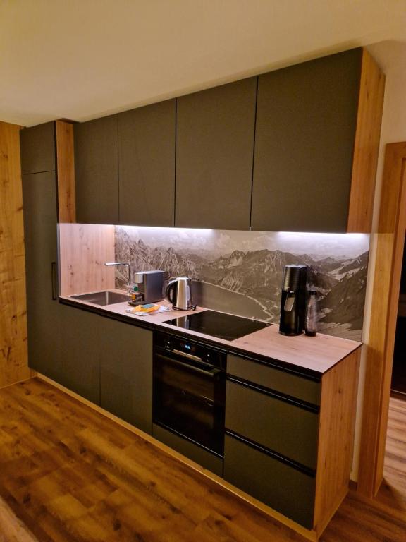 a kitchen with a sink and a stove at Haus Rätikon in Brand