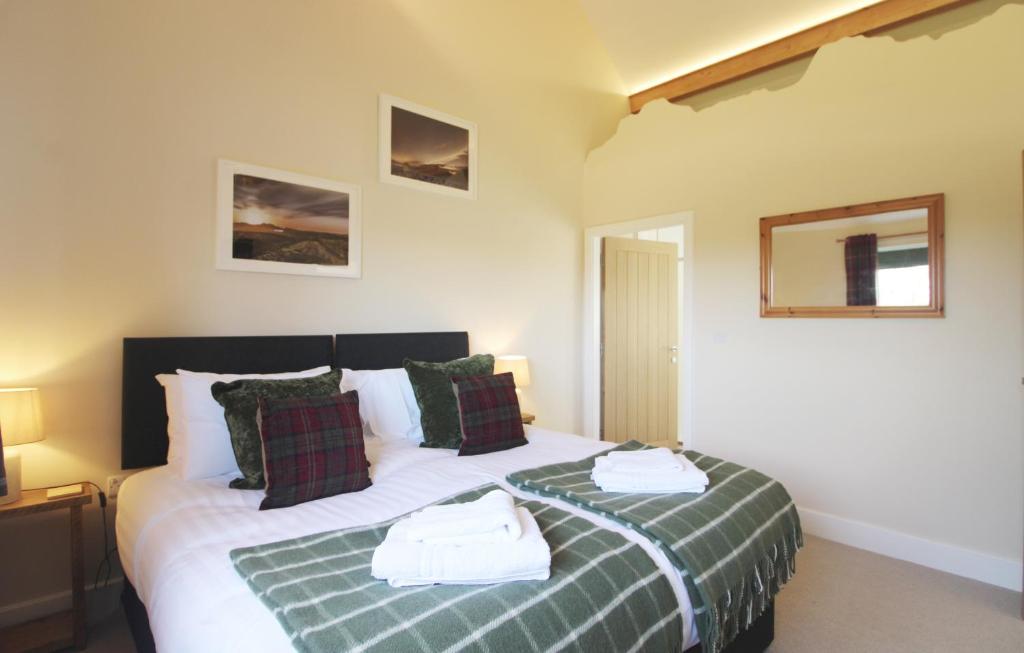 a bedroom with two beds with towels on them at Bridge House in Haltwhistle