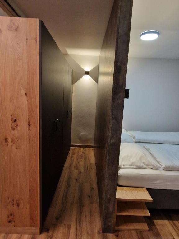 a small room with a bed and a closet at Haus Rätikon in Brand