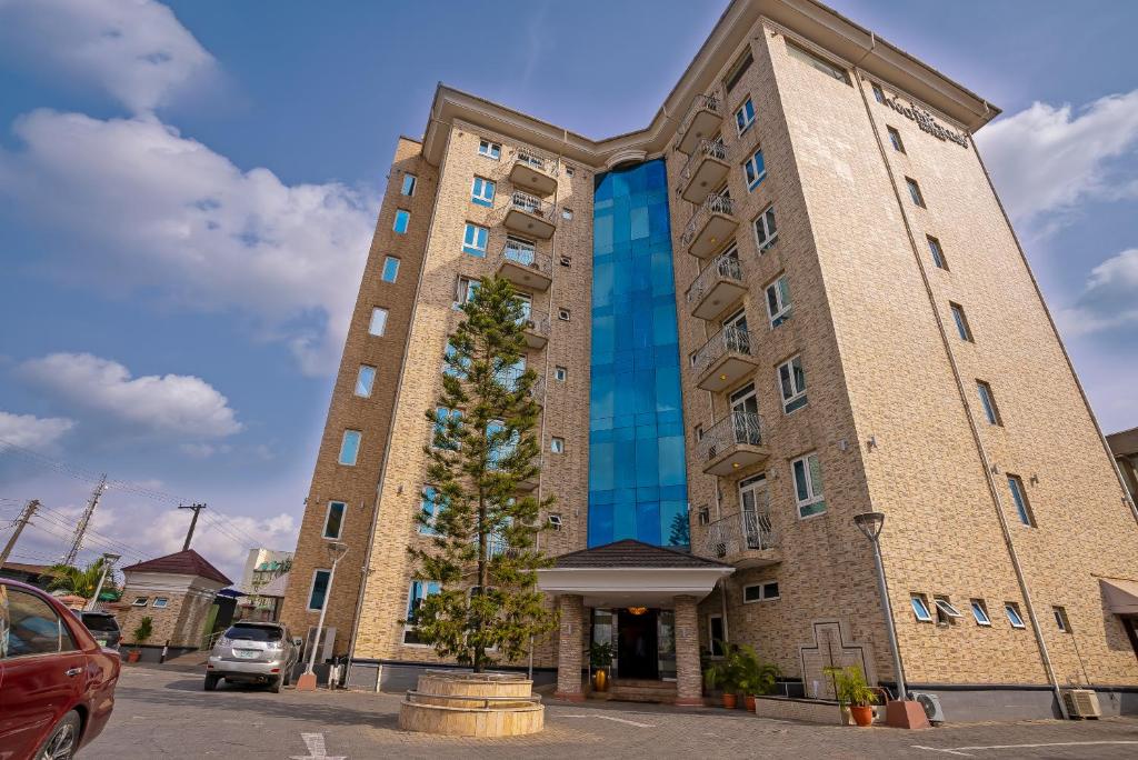 a tall brick building with a window at Watercress Hotels and Event in Ikeja