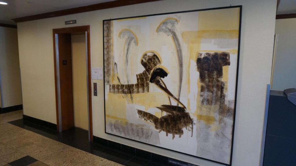 a large painting of birds on a wall in a hallway at Flushing Motel in Queens