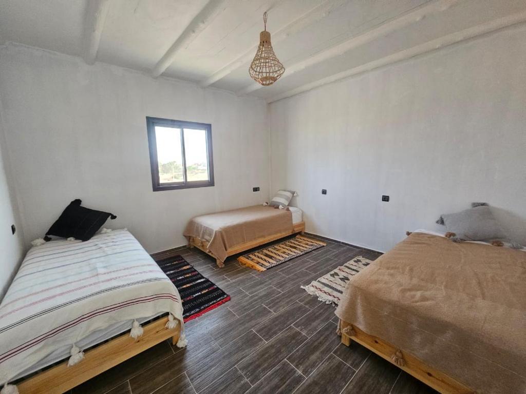 a bedroom with two beds and a window at Atlanticguesthouse in Agadir