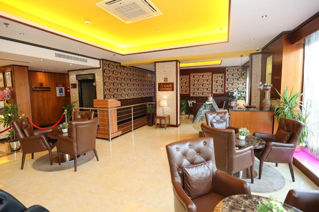 a lobby of a hotel with chairs and a waiting room at Fortune Pearl Hotel in Dubai