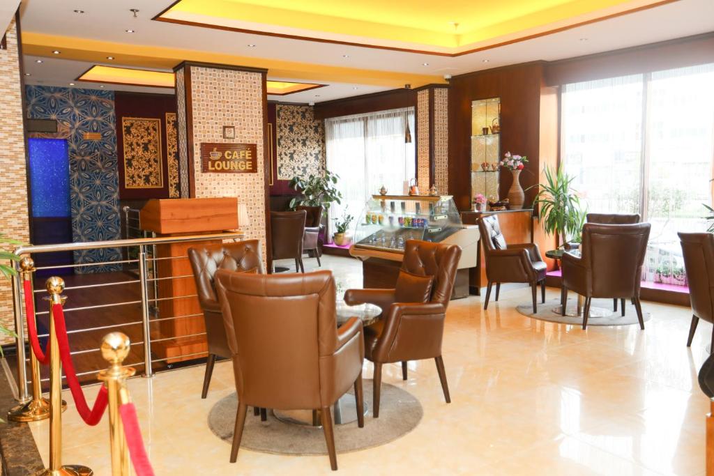 a waiting room with chairs and a table at Fortune Pearl Hotel in Dubai
