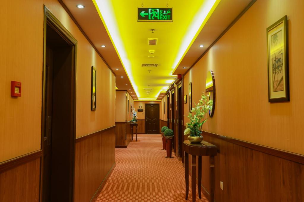 a hallway of a hospital with a clock on the ceiling at Fortune Pearl Hotel in Dubai
