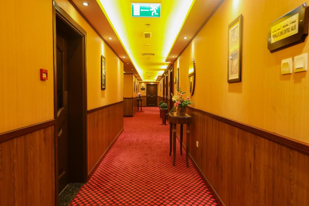 a corridor of a hospital hallway with a red floor at Fortune Pearl Hotel in Dubai