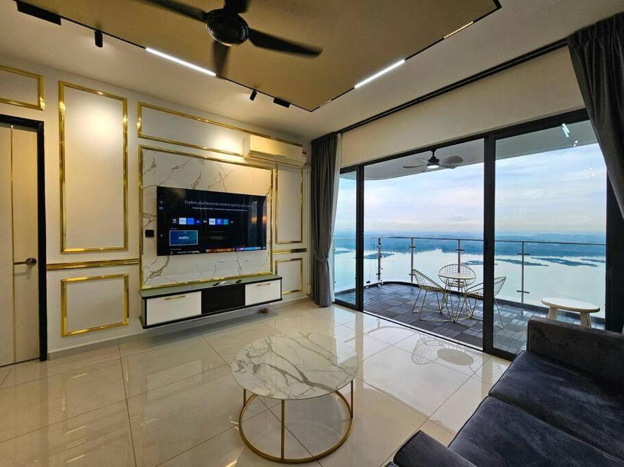 a living room with a couch and a large window at Royal Strand, Country Garden Danga Bay, Johor Bahru, Johor in Johor Bahru