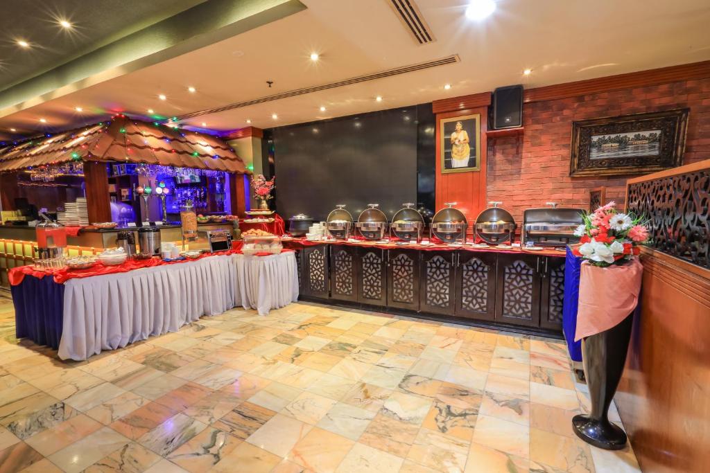 a restaurant with two tables and a carousel at Fortune Pearl Hotel in Dubai