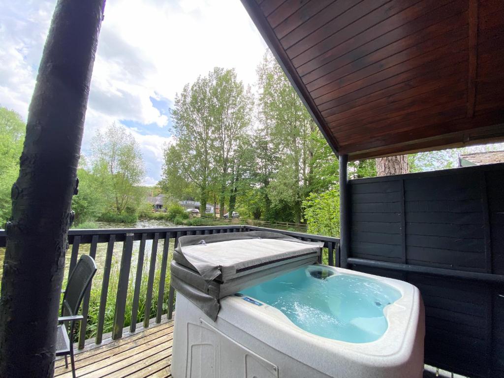 a hot tub on the deck of a house at Otter 4 Hot Tub - HuntersMoon-Warminster-Bath-Salisbury in Warminster