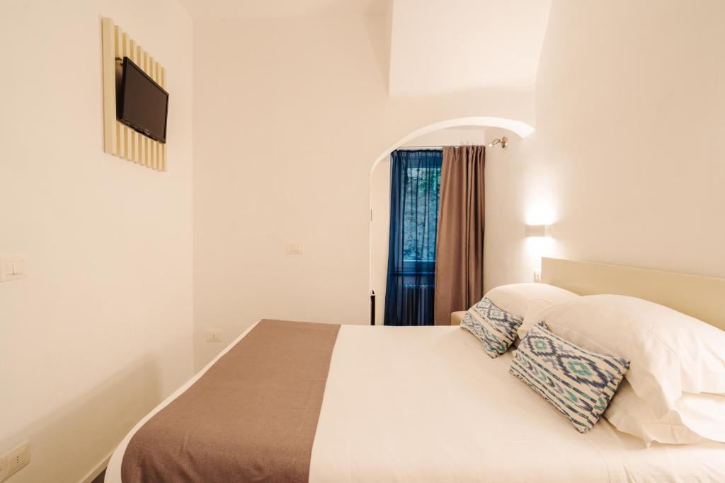 Postel nebo postele na pokoji v ubytování Oblò Portovenere Guesthouse