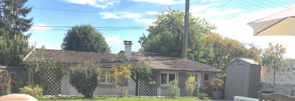 a small house with a chimney on top of it at le cottage in Apremont