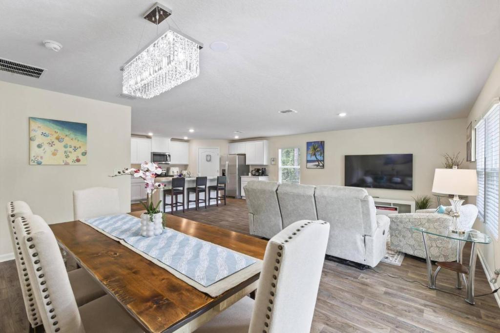 a dining room and living room with a table and chairs at Ryecrest | Palm Coast in Palm Coast