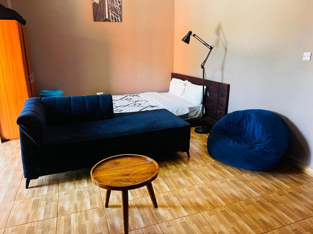 a living room with a couch and a bean bag chair at The Urban Edge in Makerere