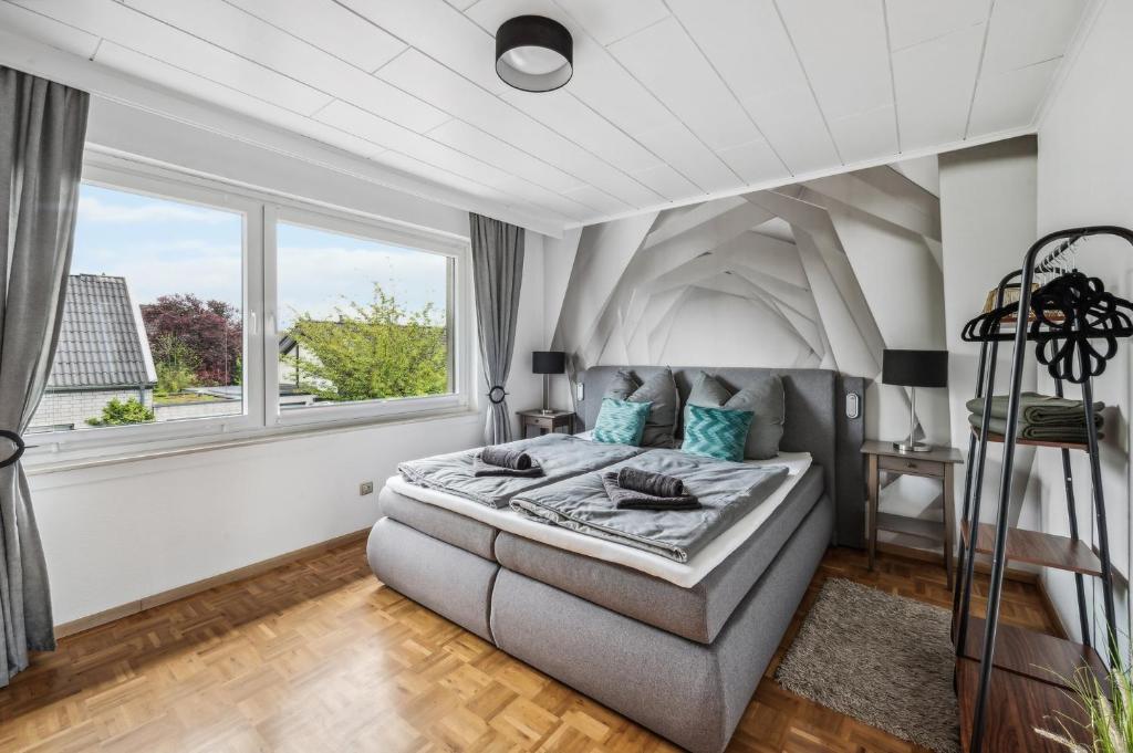 a bedroom with a large bed and a window at P&K Apartment in Dinslaken