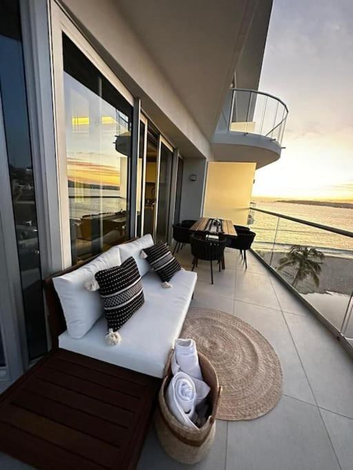 a white couch sitting on top of a balcony at Rooftop Pool Suites Vallarta in Bucerías