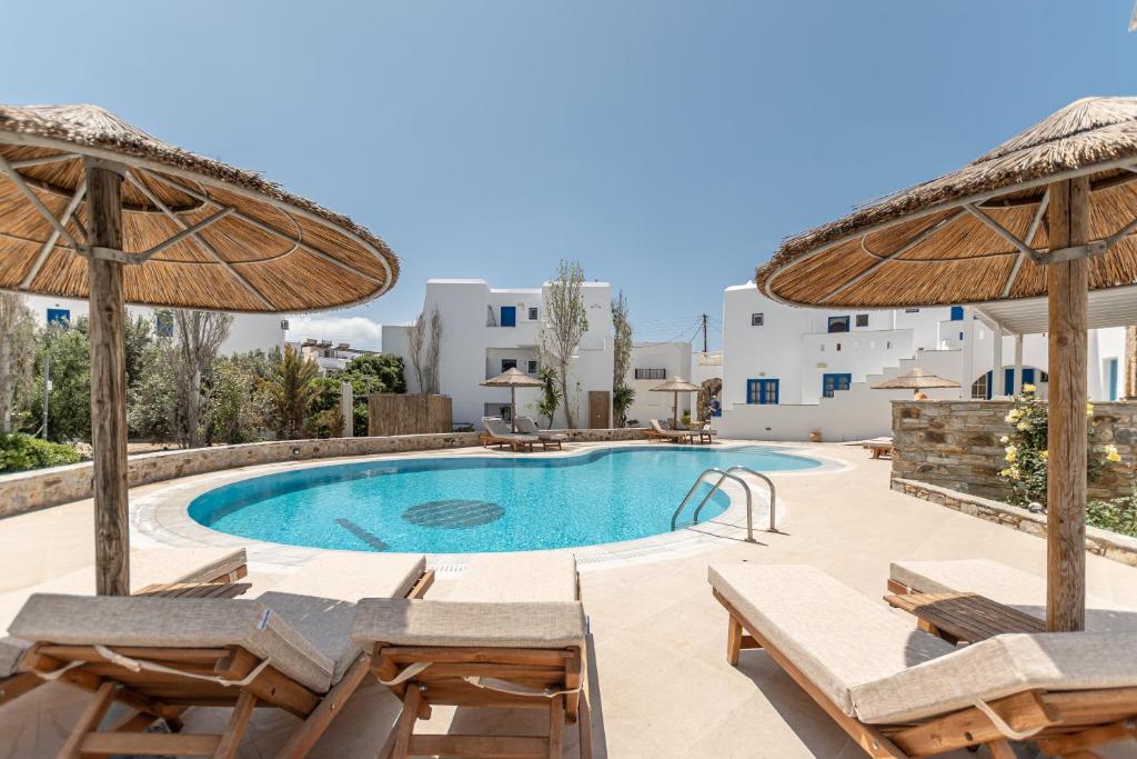 a pool at a hotel with chairs and umbrellas at Hotel Francesca in Agios Prokopios