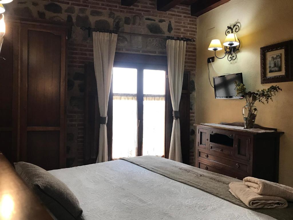 Postel nebo postele na pokoji v ubytování Hospederia Casa de Cisneros
