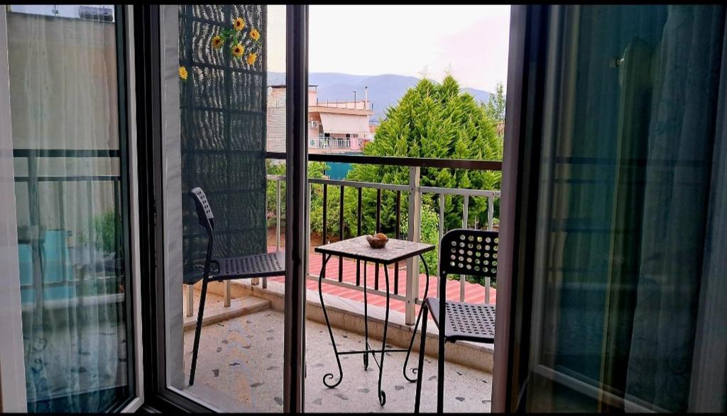 een balkon met een tafel en stoelen bij Compass in Kavala