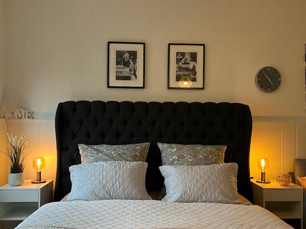 a bedroom with a large bed with two lamps on tables at Luxus Appartement in zentrale Lage von Siegburg in Siegburg