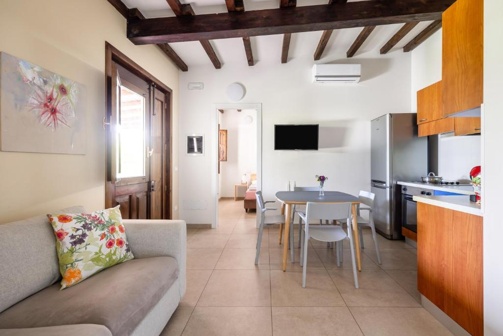 a living room with a couch and a table at Fiore di Vendicari B&B - Sicilian Charme, Lemon Grove and Sea in Noto