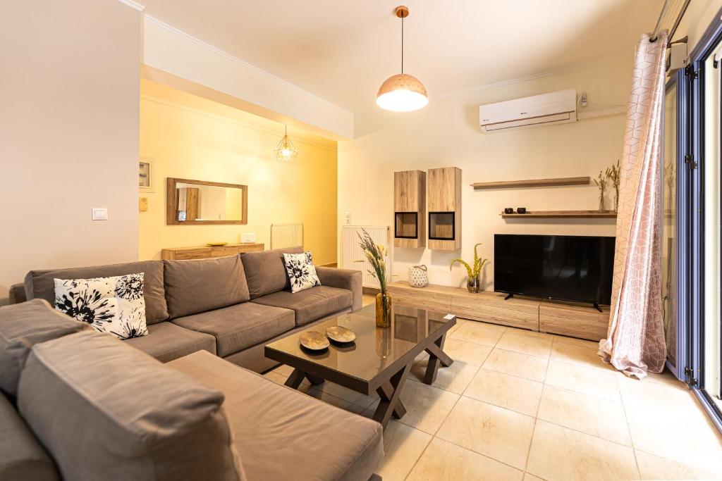 a living room with a couch and a table at FoRest & sea view apartment in Argostoli