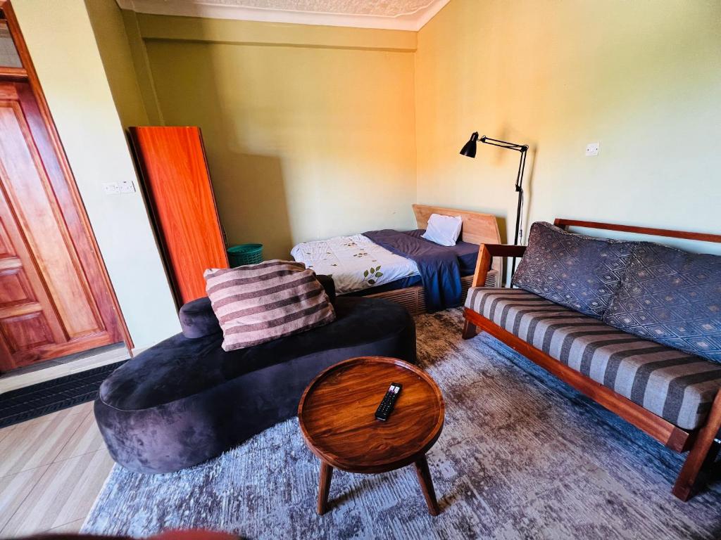 a living room with a couch and a table at Botique Inn in Kampala