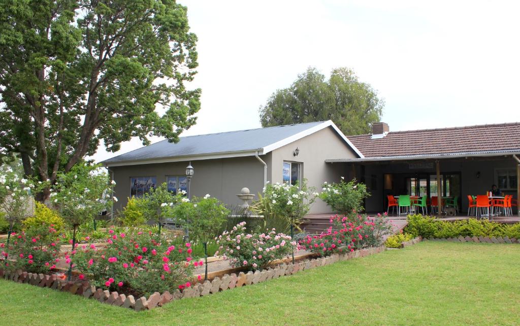a house with a garden in front of it at The Itumeleng Guest House in Bergville