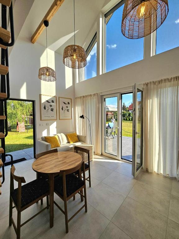 a living room with a table and chairs at Binibona Barn Haven Rydzewo in Rydzewo