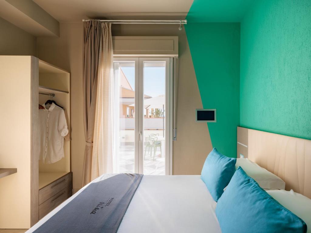 Ένα ή περισσότερα κρεβάτια σε δωμάτιο στο Hotel Nina