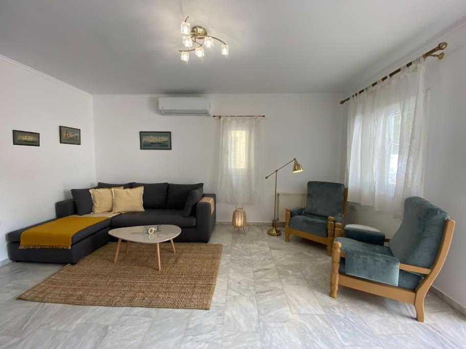 a living room with a couch and two chairs at Mermaid apartment Nafplio in Nafplio