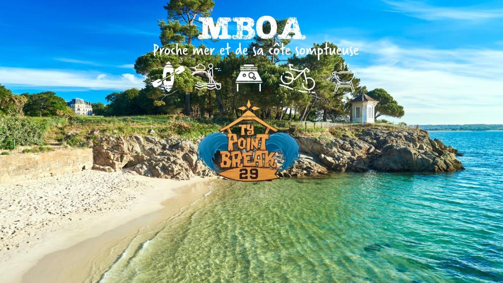 a sign on a beach next to the water at Maison Mboa in Fouesnant