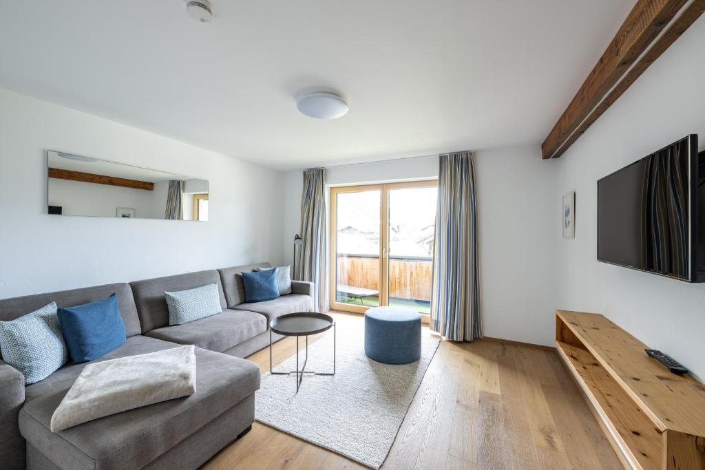 a living room with a couch and a tv at Haus Tannberg in Riezlern
