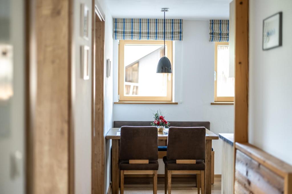 a dining room with a table and two chairs at Haus Tannberg in Riezlern