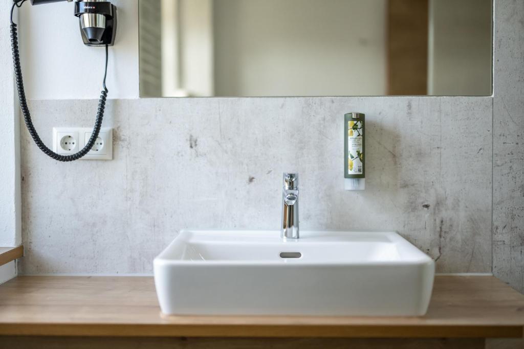 a white sink in a bathroom with a mirror at Haus Tannberg in Riezlern