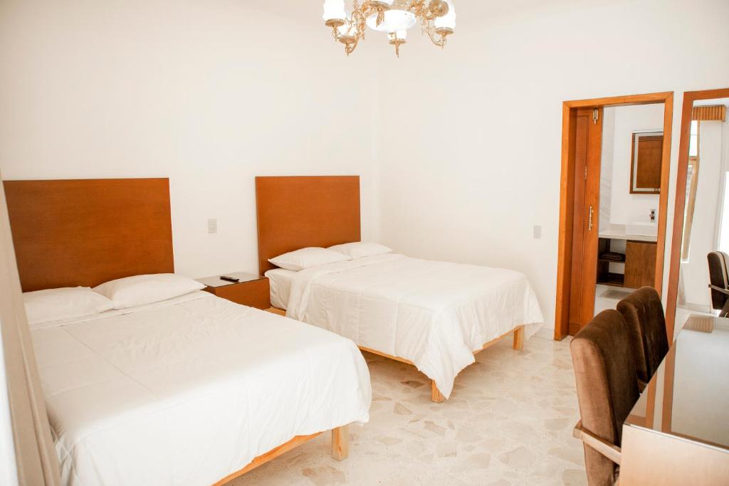Postel nebo postele na pokoji v ubytování Violeta Hotel Boutique