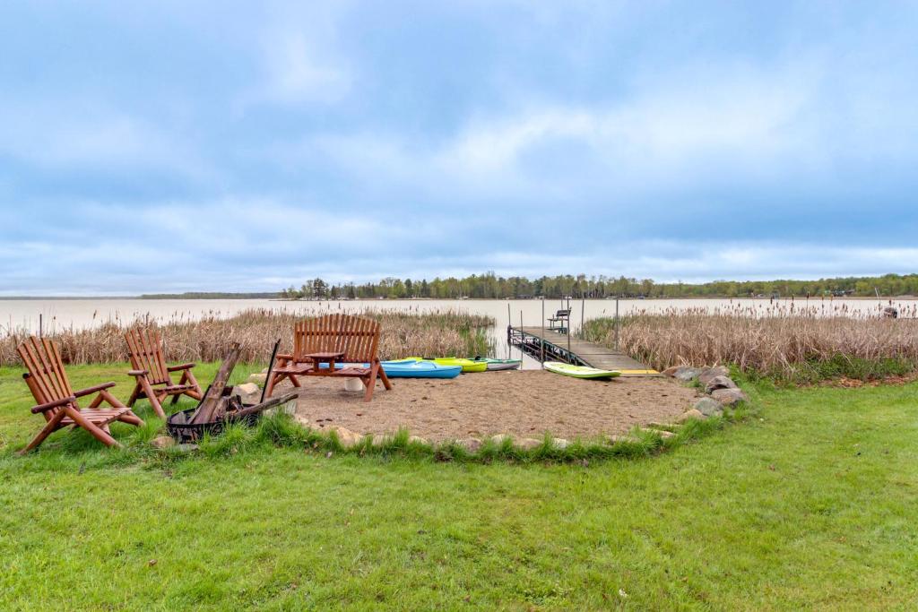 two chairs and a picnic table in the grass at Away at Moose Bay Breezy Point Gem with Game Room in Breezy Point