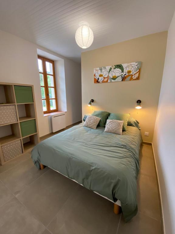 Ένα ή περισσότερα κρεβάτια σε δωμάτιο στο Le Pied de Ville Morgon