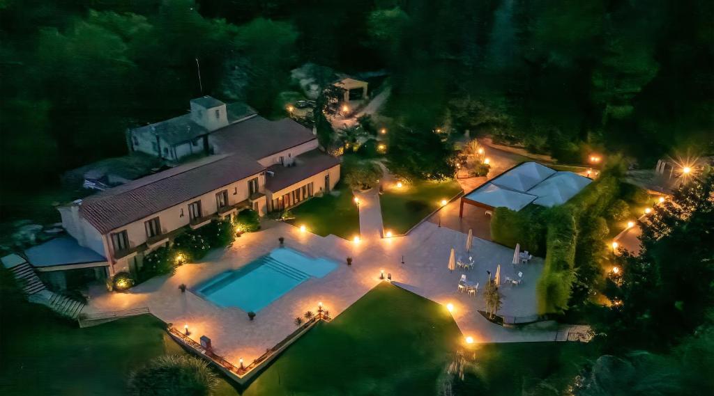 an overhead view of a house with a pool at night at CAN MARLET MONTSENY Hotel Boutique in Montseny