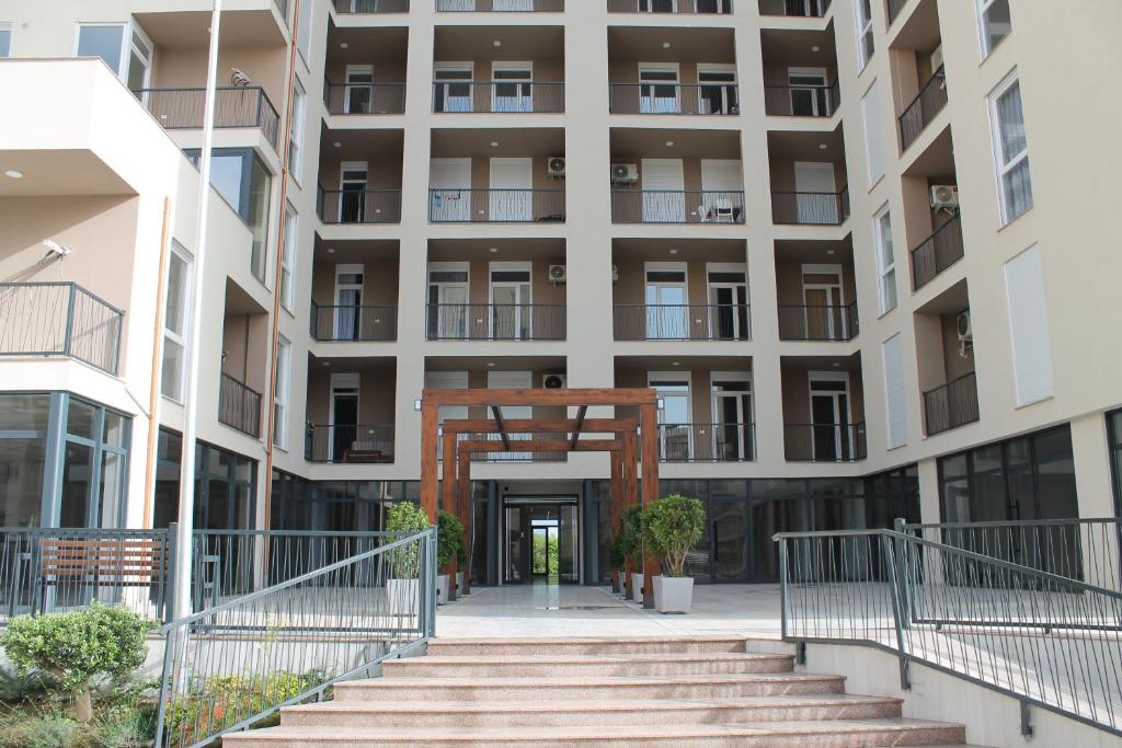 an external view of a building with stairs in front at Holiday Gateway in Shëngjin