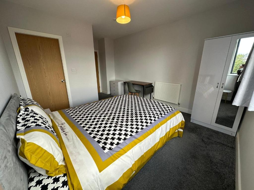 a bedroom with a bed and a table in it at Central Unite management Ltd in Manchester